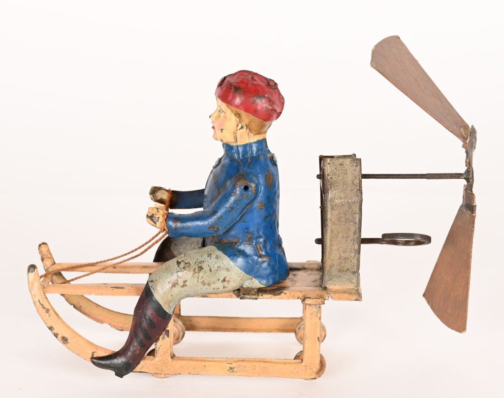 GERMAN HAND PAINTED TIN WINDUP BOY ON SLED (1 of 6)