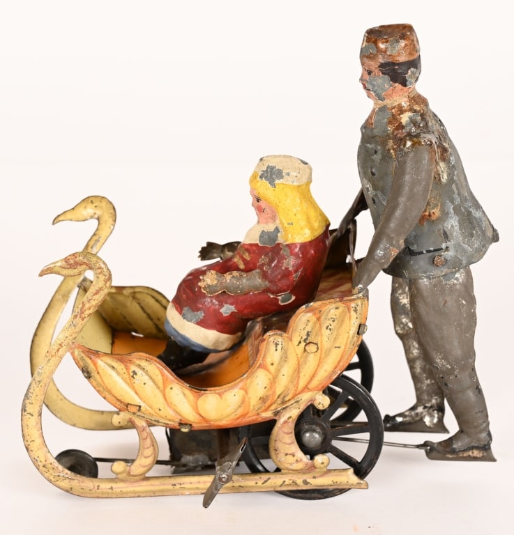 GERMAN HAND PAINTED TIN MAN PUSHING WOMAN IN SLED (1 of 6)