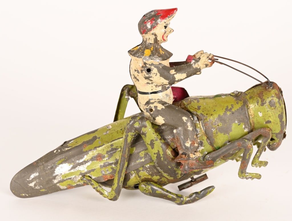 HANS EBERL HAND PAINTED TIN CLOWN ON GRASS HOPPER: German hand painted tin windup Clown on Grass Hopper. All original condition. Windup works. 8" Very Good