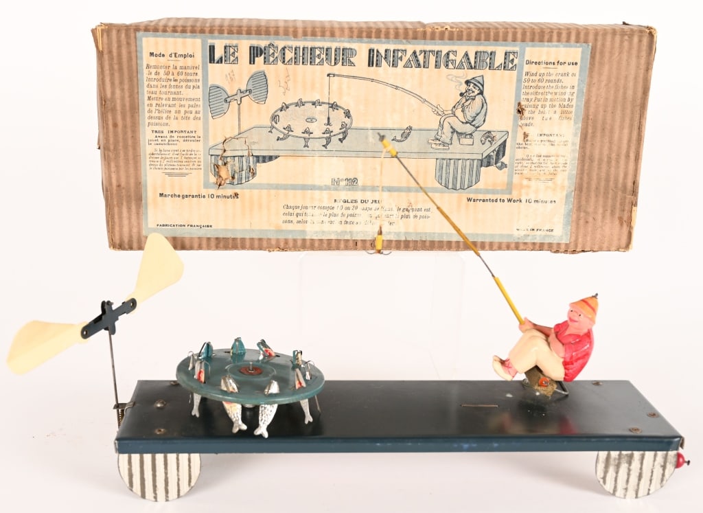 FRENCH LE PECHEUR INFATIGABLE w/ BOX: French Le Pecheur Infatigable. Tin rubber band windup Fishing Game. All original and in great shape. Works. Boxed 16" Excellent