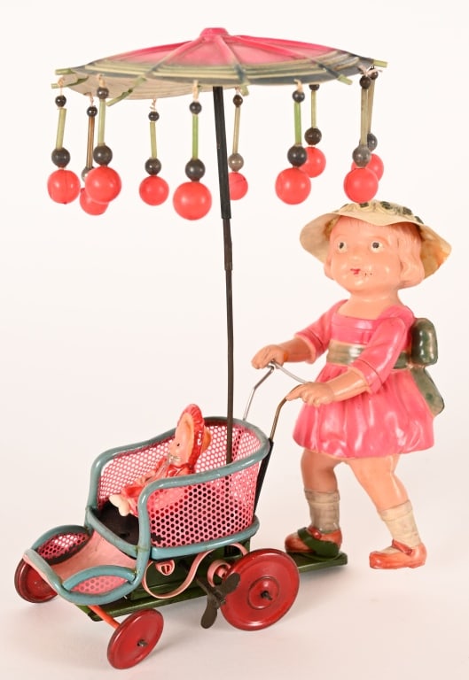 PRE-WAR JAPAN CELLULOID WINDUP LADY & CARRIAGE: Pre-War Japan celluloid windup Lady with Baby Carriage. Oversized toy. All original with celluloid Baby. Windup works. 9 1/2" Excellent