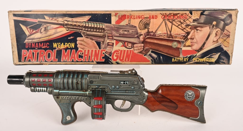 YONE BATTERY OP PATROL MACHINE GUN w/ UFO BOX: Japan battery operated Patrol machine Gun. All original in great shape. Worked when tested. Comes with great Box with UFO graphics. 21" Excellent