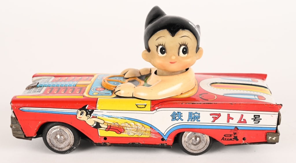 TADA TIN FRICTION ASTRO BOY CAR: Japan tin friction Astro Boy Car. All original tin 1950s style car with vinyl Astro Boy driver. Great colors and graphics. Friction works. Great Japanese Character toy! 7" Excellent