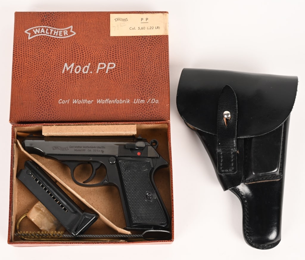 FINE BOXED WALTHER PP 22 LR WITH HOLSTER 1965: SERIAL NUMBER: 24287 BARREL: 3 7/8" CALIBER: 22 LR. MANUFACTURED: 1965 Metal is high polished blue steel with standard sights. Walther banner checkered black plastic grips are present. Walther address