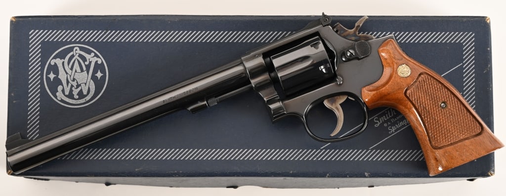 SMITH & WESSON MODEL 14-4 K38 MASTERPIECE: SERIAL NUMBER: 75K0025. BARREL: 8 3/8”. CALIBER: .38 special. MANUFACTURED: 1974. This fine Model 14-4 is equipped with an 8 3/8" barrel, original bright blue finish and checkered walnut target
