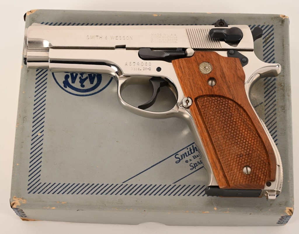 SMITH & WESSON MODEL 39-2 NICKEL 9MM ANIB: SERIAL NUMBER: A216033. BARREL: 4”.CALIBER: 9MM Luger. MANUFACTURED: 1974. This 1974 built Model 39 is complete in the original numbers matching grey two piece Bangor Punta box with the factory