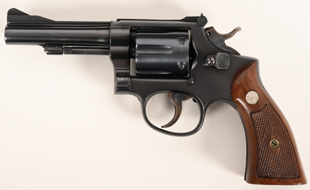 SMITH & WESSON PRE MODEL 15 38 COMBAT MASTERPIECE: SERIAL NUMBER: K222135. BARREL: 4”. CALIBER: .38 Special. MANUFACTURED: 1954. This Pre Model 15 aka .38 Combat Masterpiece was built with a 4” barrel, original satin blue finish and checke
