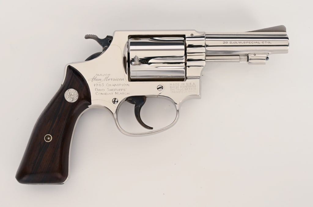 OHIO SHERIFF PRESENTATION SMITH & WESSON MODEL 36: SERIAL NUMBER: 314774. BARREL: 3”. CALIBER: .38 Special. MANUFACTURED: 1963. This special ordered factory presentation inscribed Model 36 is equipped with a 3” barrel, special square butt