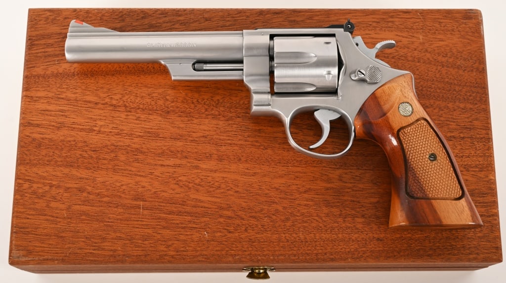 SMITH & WESSON MODEL 629 NO DASH P&R 44 MAGNUM NIB: SERIAL NUMBER: N777457. BARREL: 6 1/2”. CALIBER: .44 Magnum. MANUFACTURED: 1980. This pinned and recessed early first year production Model 629 is complete in the restored interior mahogany disp