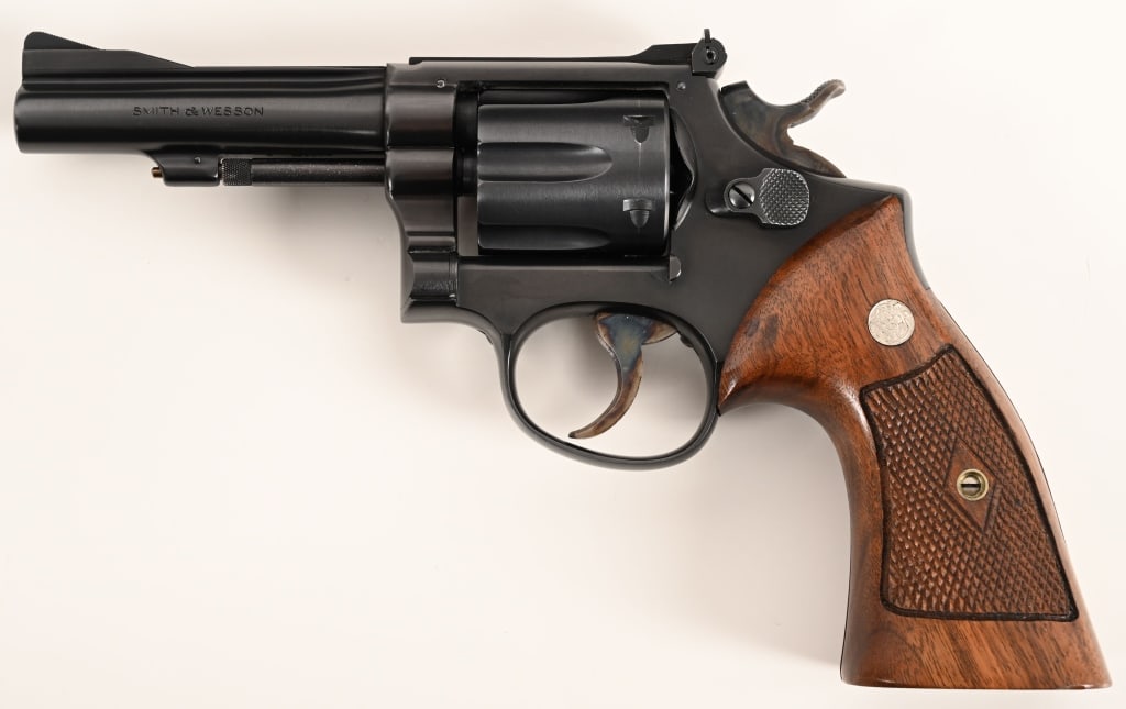 SMITH & WESSON PRE MODEL 18 K22 COMBAT MASTERPIECE: SERIAL NUMBER: K228877. BARREL: 4”. CALIBER: .22 LR. MANUFACTURED: 1954. Built on the five screw frame this early Pre Model 18 aka .22 Combat Masterpiece is equipped with a 4” barrel, orig