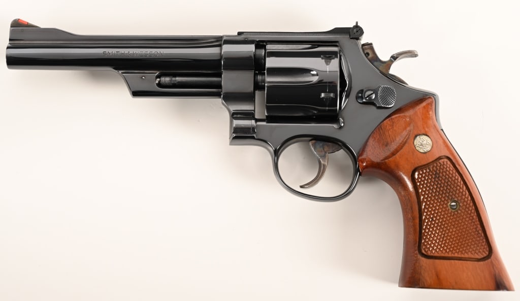 SMITH & WESSON MODEL 27-2 357 MAGNUM: SERIAL NUMBER: N217150. BARREL: 6”. CALIBER: .357 Magnum. MANUFACTURED: 1974-1975. This pinned and recessed Model 27-2 is equipped with a 6” barrel, original bright blue finish, red ramp a