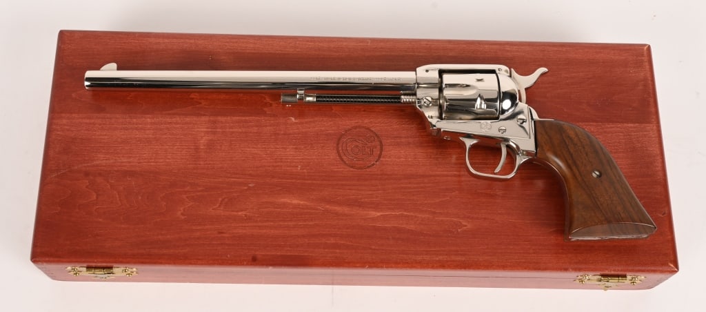 CASED NICKEL COLT SINGLE ACTION BUNTLINE SCOUT: SERIAL NUMBER: 39128K BARREL: 9 1/2" CALIBER: 22 LR. MANUFACTURED: 1968 Made in the USA. Metal is bright nickel finish with standard sights. Smooth oil finished hardwood grips. Colt logo presentation