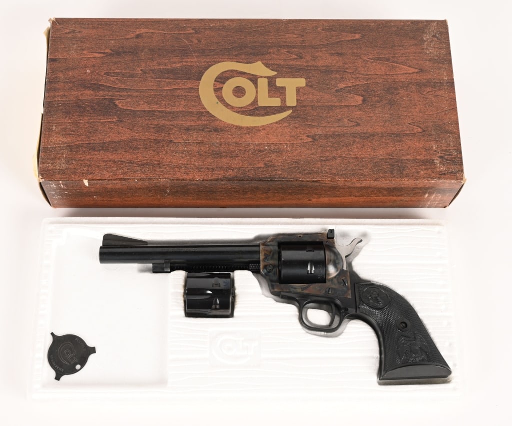 BOXED COLT NEW FRONTIER SINGLE ACTION 22: SERIAL NUMBER: G192173 BARREL 6.0" CALIBER: 22 LR - 22 MAG. MANUFACTURED: 1976 Made in the USA. Metal is blue finish with case hardened frame. Adjustable target style rear sight with ramped front.