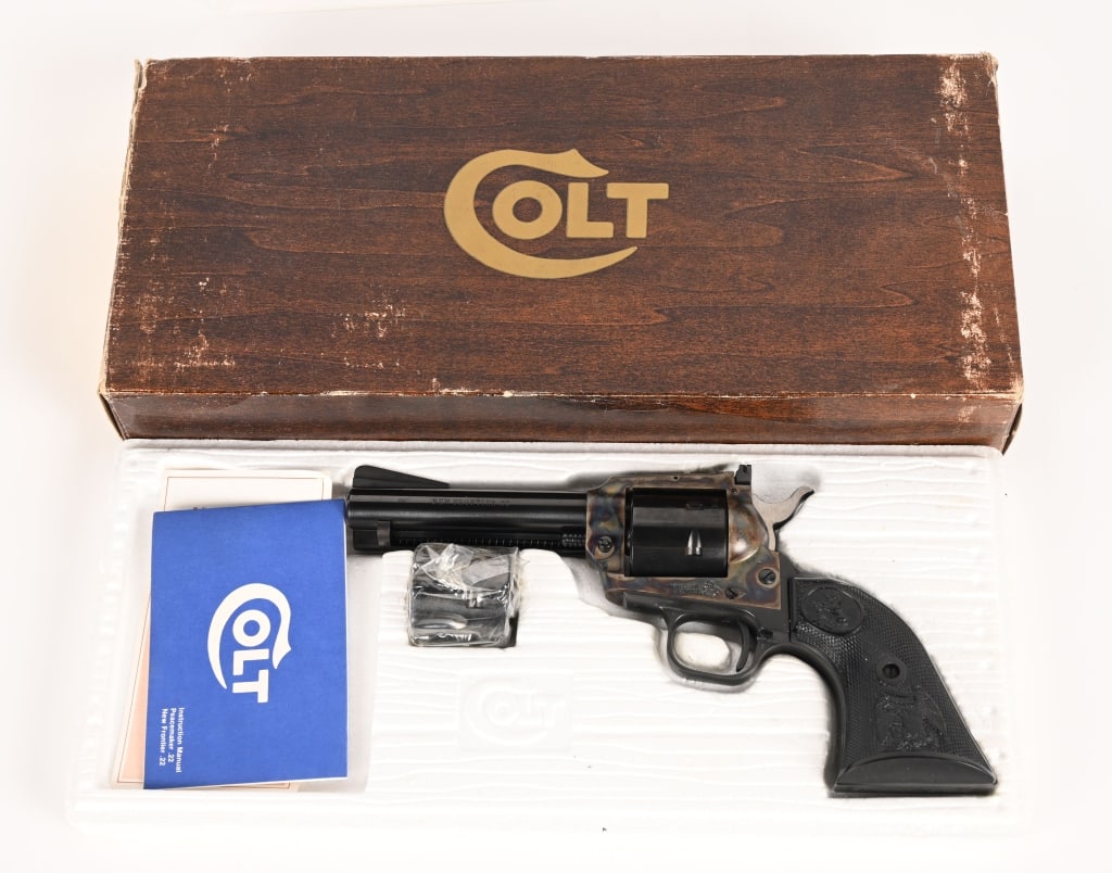 BOXED COLT NEW FRONTIER SINGLE ACTION 22: SERIAL NUMBER: G104231 BARREL: 4.4" CALIBER: 22 LR - 22 MAG. MANUFACTURED: 1974 Made in the USA. Metal is blue finish with case hardened frame. Adjustable target style rear sight with ramped front.