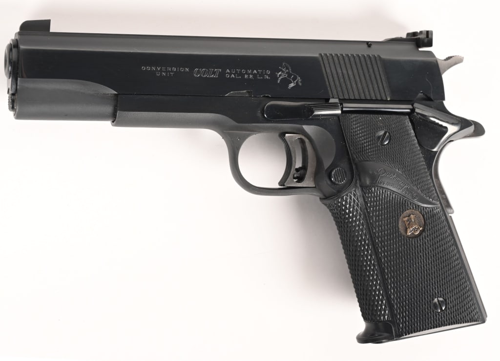 COLT GOLD CUP NATIONAL MATCH 1911 .22 LR CONVER: SERIAL NUMBER: 70N22890. BARREL: 5". CALIBER: .22 LR. MANUFACTURED: 1975. This colt Gold Cup frame is outfitted with the COLT .22 conversion unit. It also features an adjustable rear sight, the expect
