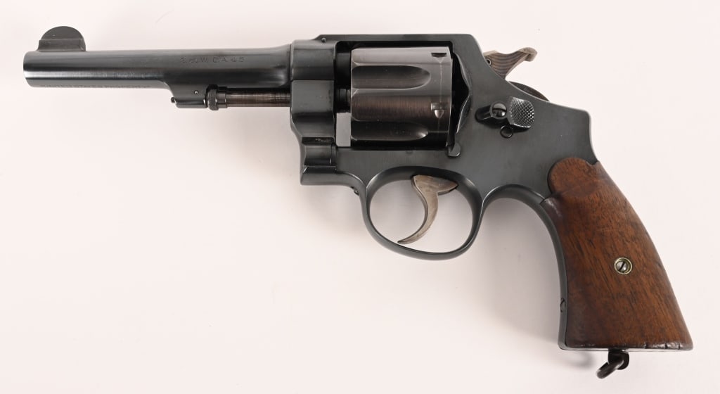 SMITH & WESSON 1ST YEAR 1917 EARLY FEATURES: SERIAL NUMBER: 7857 BARREL: 5 1/2” CALIBER: .45 ACP MANUFACTURED: 1917 This first year Model 1917 army has both the concentric grooved hammer and the concave smooth walnut service grips.