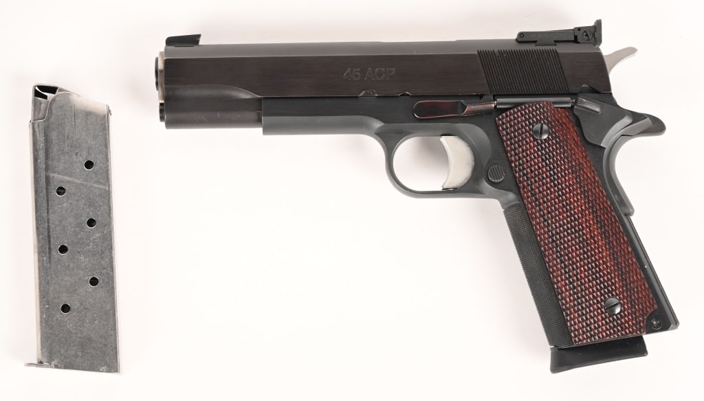 LES BAER CUSTOM 1911 SEMI AUTOMATIC PISTOL: SERIAL NUMBER: LB18943. BARREL: 5". CALIBER: .45 ACP. This Les Baer pistol features a blued finish, checkered hardwood grips. Single action Browning designed tilting barrel recoil operated semi-custom