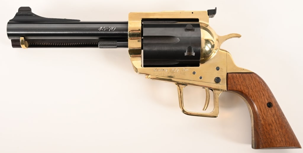 CENTURY MFG MODEL 100 45-70 HAND CANNON: SERIAL NUMBER: 921 BARREL: 6 1/2”. CALIBER: .45-70. MANUFACTURED: 1975 This enormously unique Century Model 100 is equipped with a brass frame, blued steel barrel and cylinder with the original