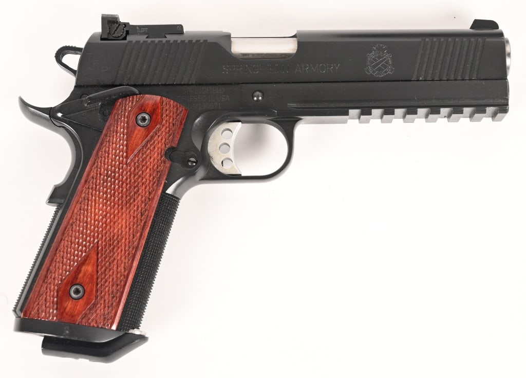 SPRINGFIELD OPERATOR 45 ACP TACTICAL 1911: SERIAL NUMBER: NM190671 BARREL: 5” CALIBER: .45 ACP MANUFACTURED: 2000. This unique Springfield Armory Operator is equipped with checkered grip straps, light rail, extended magwell and large