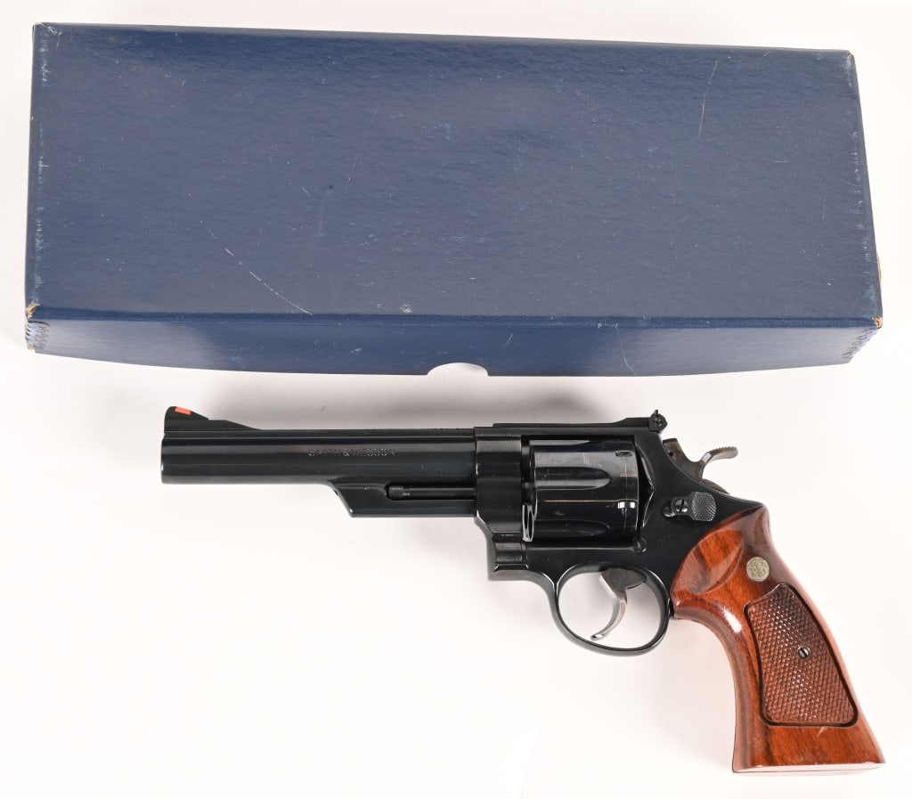 SMITH & WESSON MODEL 25-5 .45 COLT: SERIAL NUMBER: N715801. BARREL: 6". CALIBER: .45 Colt. MANUFACTURED: 1980. Built in 1980 this Model 25-5 is equipped with a 6" pinned barrel, original bright blue finish and checkered Goncalo Alves ta