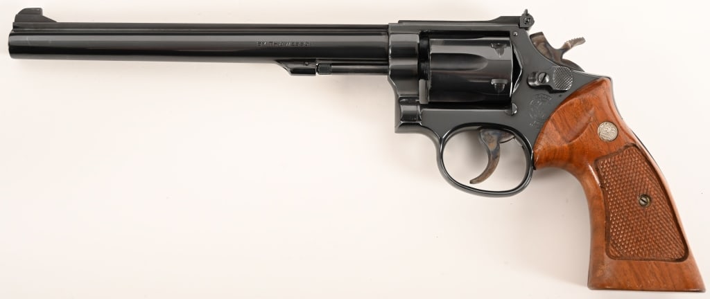 SMITH & WESSON MODEL 17-4 K-22 MASTERPIECE: SERIAL NUMBER: 246K729. BARREL: 8 3/8". CALIBER: .22 LR. MANUFACTURED: 1983. This transition Model 17-4 is equipped with an 8 3/8" barrel, original bright blue finish and checkered walnut target