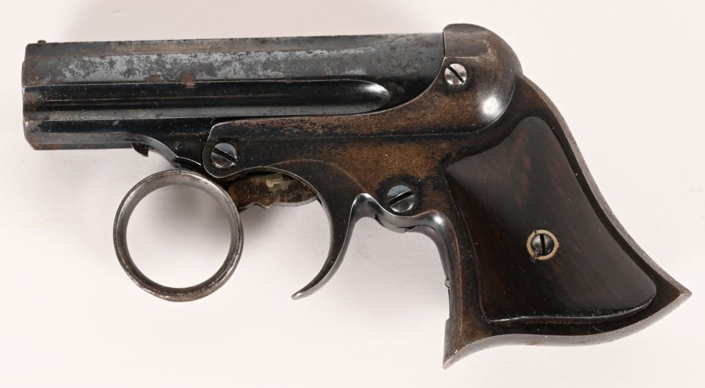 REMINGTON ELLIOT PEPPERBOX DERINGER 22 RIM FIRE: SERIAL NUMBER: 10855, BARREL: 3" CALIBER 22 Rim Fire, MFG: 1863-70'S. Five shot ring trigger 22 Pepperbox. Blue finished with 2 piece rosewood grips. 2 line Remington address on top of fluted barrel