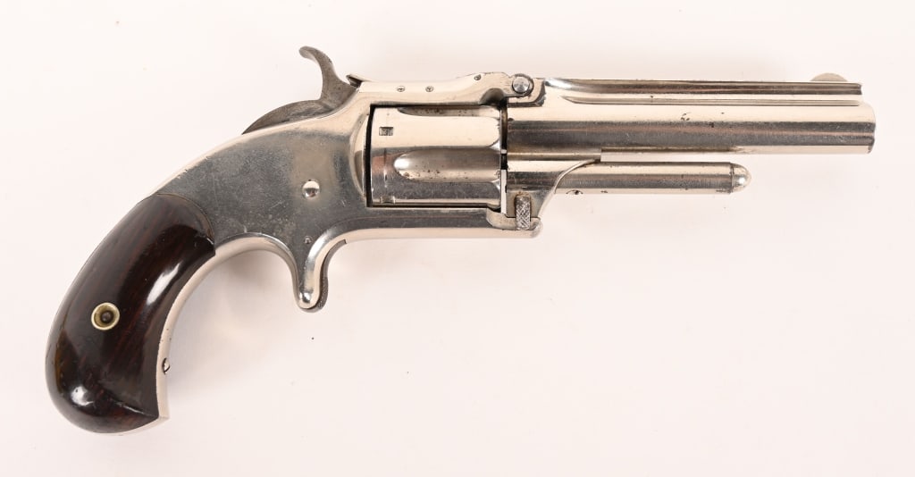 SMITH & WESSON 1 1/2 NEW MODEL: SERIAL NUMBER: 58623. BARREL: 3 1/2”. CALIBER: .32 RIMFIRE. MANUFACTURED: 1870. A fine shootable antique 1 1/2 New Model that is equipped with the original piano finish rosewood grips.