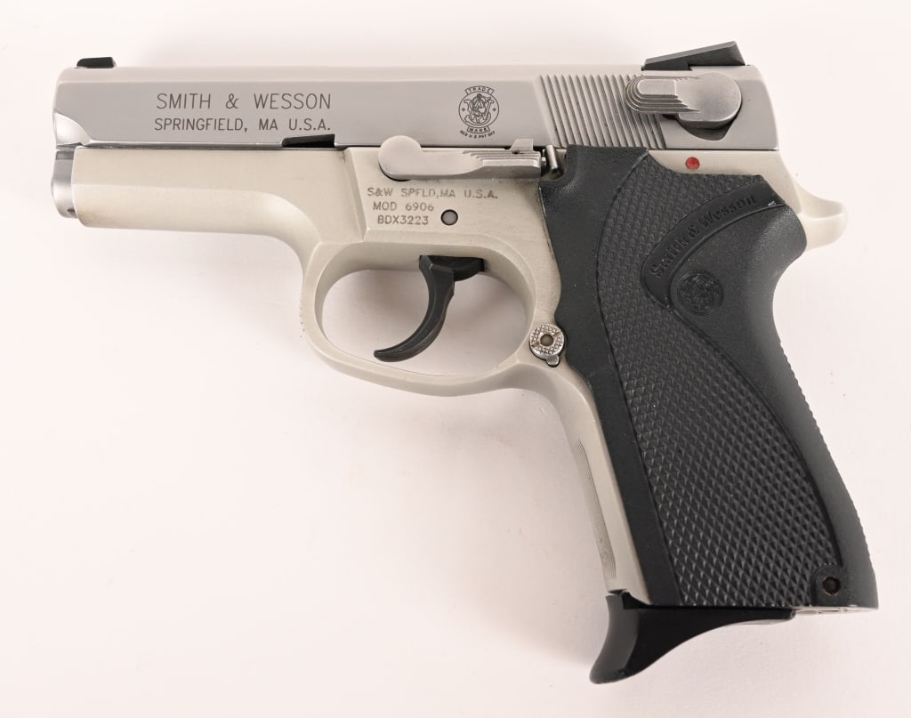 SMITH & WESSON MODEL 6906: SERIAL NUMBER: BDX3223 BARREL: 3” CALIBER: 9MM MANUFACTURED: 2005~ This fine stainless steel and anodized aluminum Model 6906 comes with the factory 11 round magazine. CONDITION: The gun