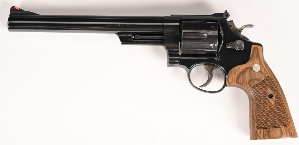 SMITH & WESSON MODEL 29 REVOLVER 44 MAGNUM: SERIAL NUMBER: AVY2024. BARREL: 8 3/8". CALIBER: .44 MAGNUM. MANUFACTURED: circa 1987. The solid rib barrel has a red ramp front sight, and a white outline adjustable rear sight, a casehardened