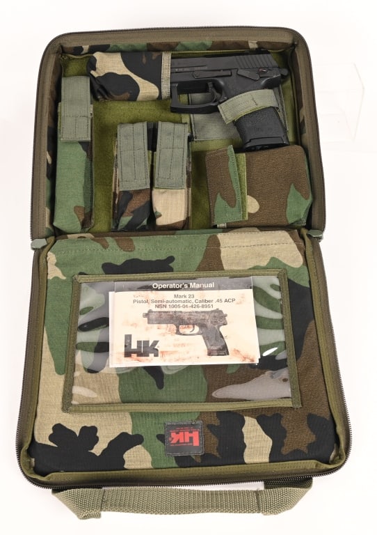 HK MARK 23 SEMI AUTO PISTOL WITH CAMMO CASE: SERIAL NUMBER: 23-010200. BARREL: 5 3/4". CALIBER: .45 ACP. MANUFACTURED: 2003. The MK 23 was developed for SOCOM as an offensive handgun. Oversized for use with gloves. White dot sights, drift adjust