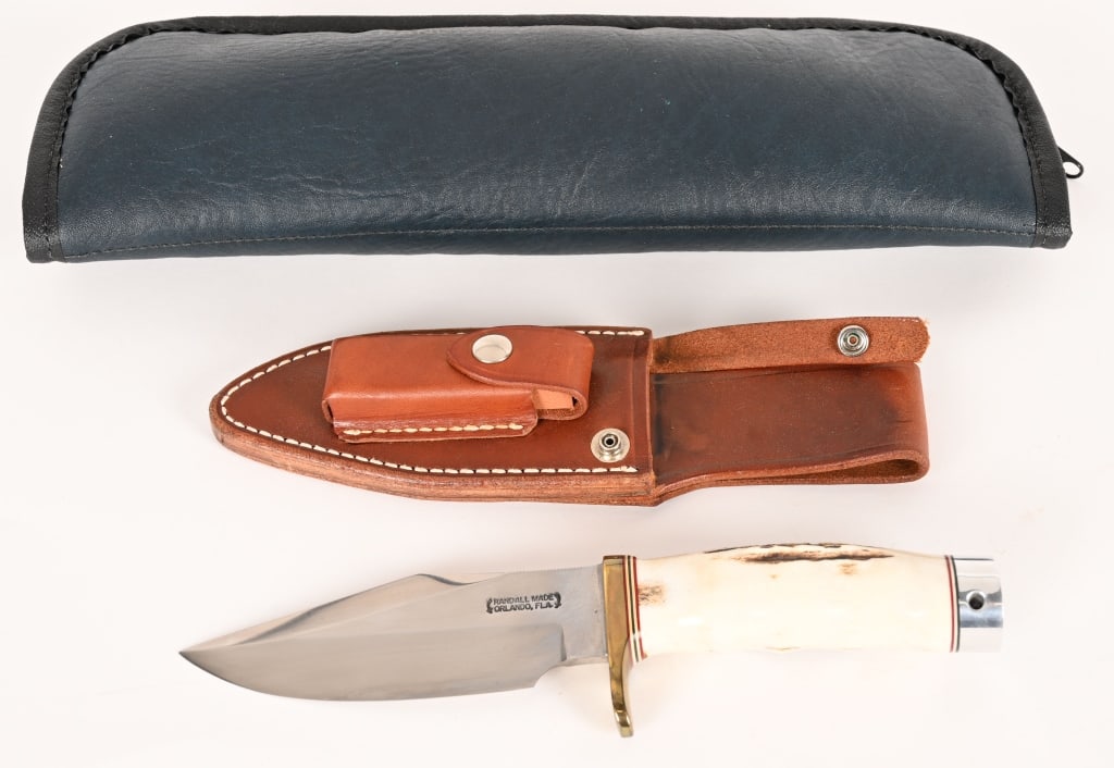 RANDALL MADE MODEL 19 BUSHMASTER KNIFE: BLADE: 5". OAL:9 3/4". This model 19 features a clip-point blade with sharpened top edge, 0.23" blade stock, 1.6" blade width, finger grooved tag handle, brass guard and duralumin pommel. Leather shea