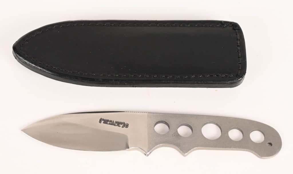 RANDALL MADE KNIFE MODEL TRIATHLETE: The Triathlete is a non-catalog knife by Randall Made Knives. It has a satin finished blade with notched thumb rest, 0.9" blade width, integral construction. Notched thumb rest. Bead blast handle. Com