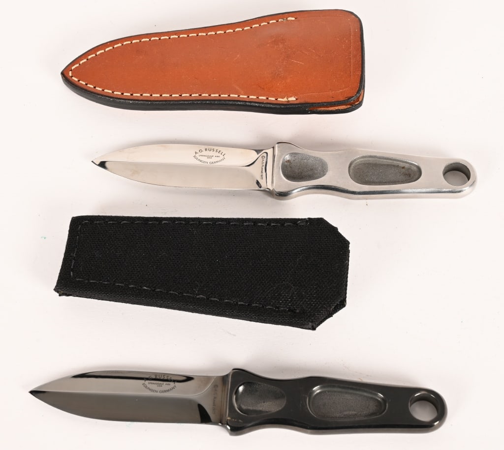AG RUSSEL STING DAGGERS 1977: BLADE: 3 1/4". OAL: 6 3/4". BLADE STOCK: 0.33". BLADE WIDTH: 0.89". Black nylon sheath and leather sheath included. CONDITION: Both are Very Good 98%. Minor handling / storage marks. Blades are very s