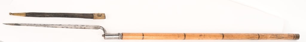 CONTINENTAL 18TH CENTURY SPEAR SOCKET BAYONET: A very unusual bayonet that is well marked at the ricasso E*C and on the socket is marked C 9*2 measuring 18 inches and is attached to a well made wood shaft that is made to accept the bayonet.