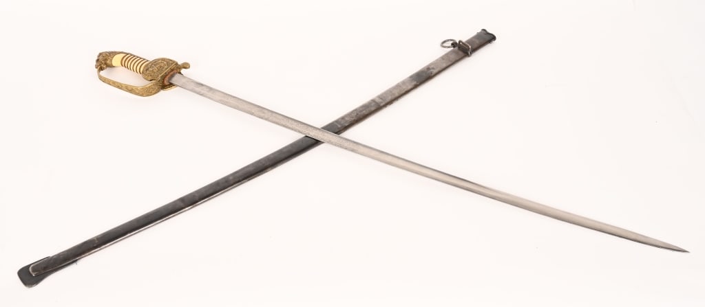 WW1 IMPERIAL GERMAN NAVY OFFICERS SWORD WWI: The saber has die cast, gilt plated, brass, hilt fittings consisting of an obverse, clam shell cross guard, a reverse, a ferrule, a "D", knuckle bow, a back-strap and a nicely detailed, pronounced lio