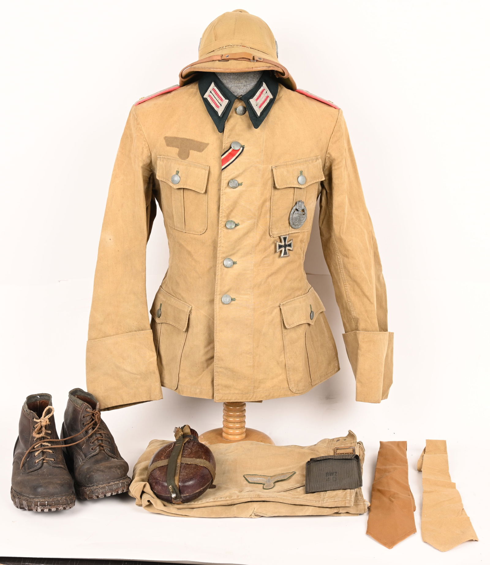 WWII NAZI GERMAN PANZER AFRIKAKORPS UNIFORM SET: Complete uniform of a Lieutenant of the AfrikaKorps in regiment 33. The lot includes 1) TROPICAL OFFICERS UNIFORM JACKET. Made of a khaki cotton duck material with a six button front. Four pleat