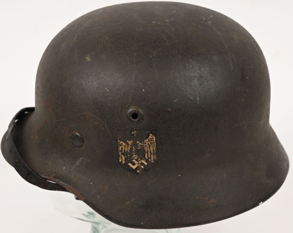 WWII NAZI GERMAN M40 WEHRMACHT SD HELMET Q64 WW2: The stamped sheet steel construction helmet retains most of its original paint. The left side of the helmet has a Wehrmacht eagle decal which is retained about 70%. The outline of the tri-color decal