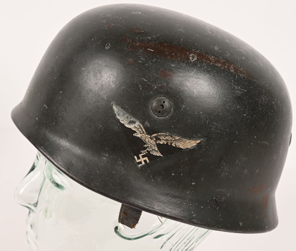 WWII LUFTWAFFE M38 FALLSCHIRMJAGER HELMET WW2: Second pattern, early war, stamped sheet steel construction, paratrooper helmet retains most of its original green/gray paint with traces of white camo paint. To its side, a beautiful National Eagle h