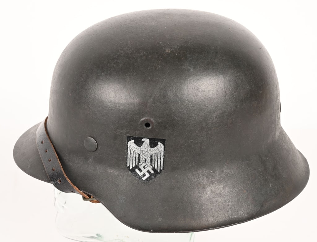 WWII NAZI GERMAN M42 EF64 SD HEER HELMET W LINER: The stamped, sheet steel construction helmet retains all of its field-gray paint. The left side of the helmet has a Wehrmacht eagle shield decal which is retained about 98%. All three liner retaining