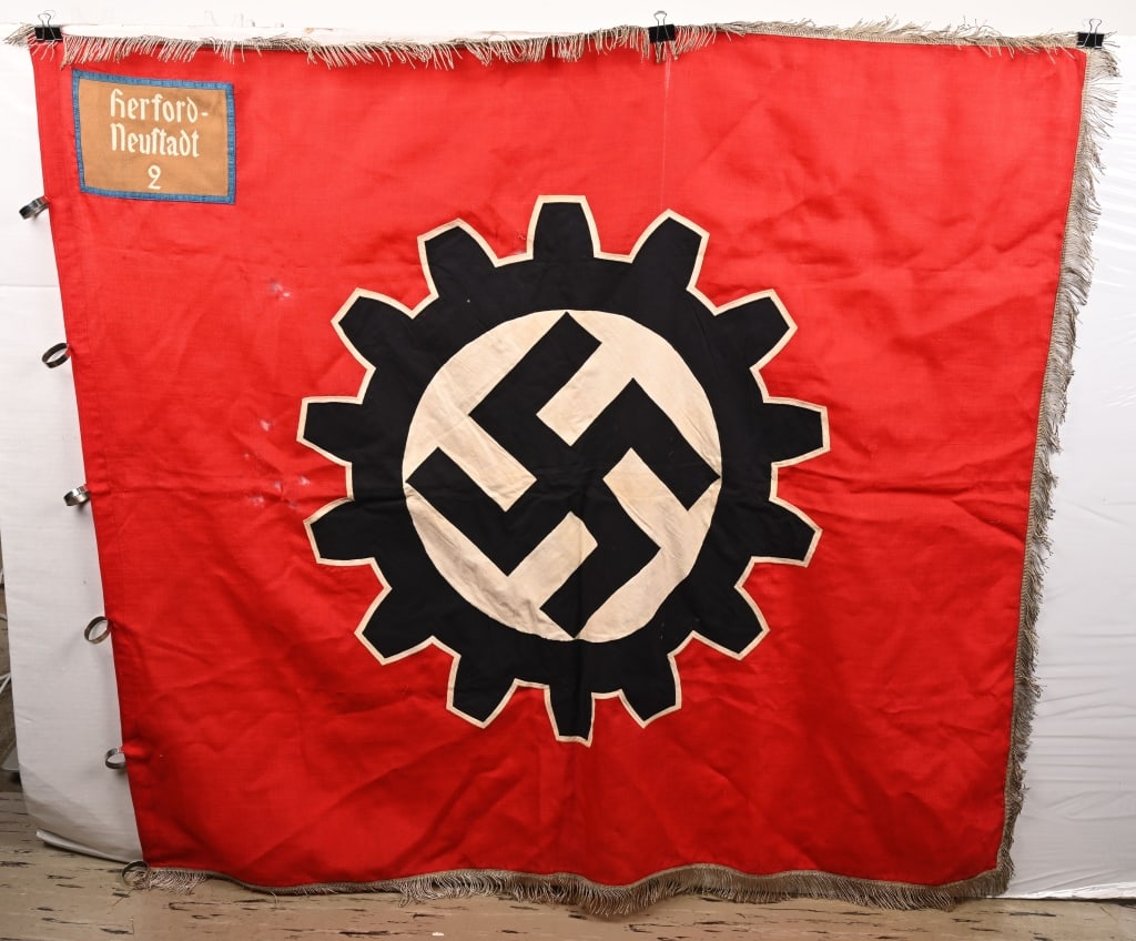 WWII NAZI GERMAN DAF FLAG with FRINGE ORTS LEVEL: A 1937 pattern, 125cm x 120cm, double-sided, multi-piece wool construction factory unit flag, trimmed to all but the hoist edge in 50mm long twisted silver/aluminum wire fringe. The flag features a