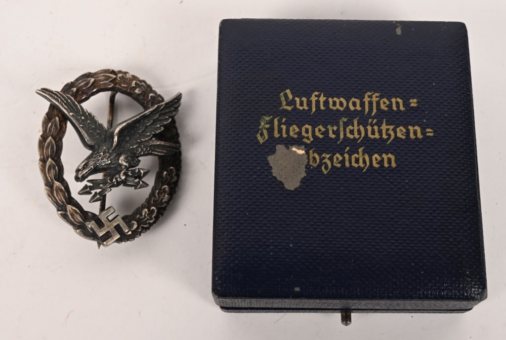 WWII NAZI LUFTWAFFE CASED WIRELESS OPERATORS BADGE: Early, nice quality, two piece, die struck alloy construction badge with nickel/silver, frosted white wash and burnished silver finishes. The badge is in the form of a nicely convexed, frosted white w