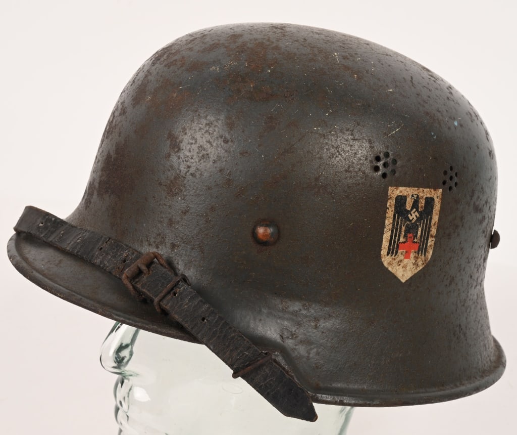 WWII NAZI GERMAN M34 DRK RED CROSS HELMET W LINER: Rare steel construction M34 "Square Dip" Third Reich helmet, outfitted for German Red Cross (DRK) use. While there were medics in the field, their services were also needed locally, and were issued th