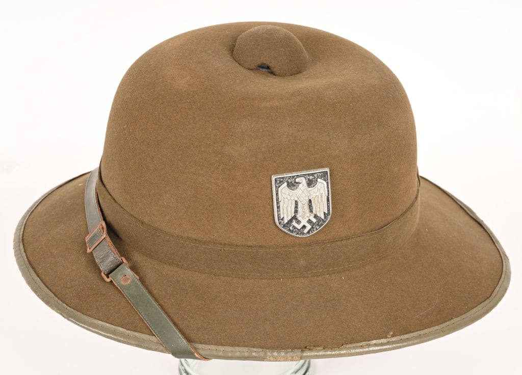 WWII NAZI GERMAN TROPICAL PITH HELMET 1941 DATED: Second pattern pith helmet constructed in a one piece seamless formed olive-drab felt crown with a horizontal band stitched at the rear center and covered by a vertical strip of felt mounted on a form