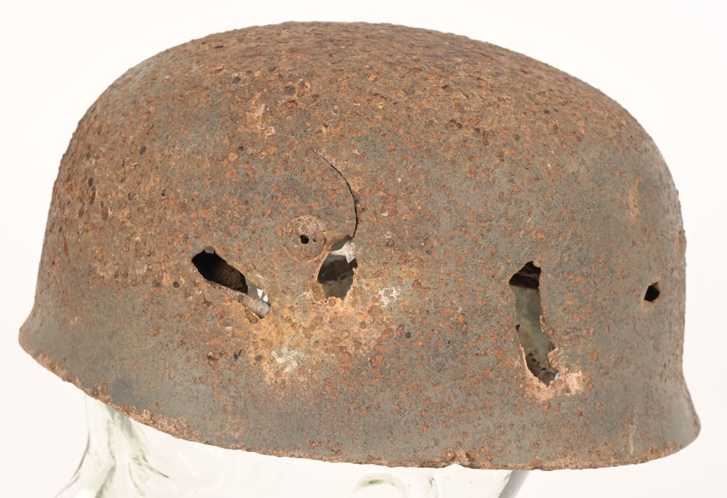 WWII DUG NAZI LUFTWAFFE M38 FALLSCHIRMJAGER HELMET: Second pattern, early war, dug, stamped sheet steel construction, paratrooper helmet retains a good portion of its original green/gray paint. Has had three bullet strikes to the side of the helmet. Po