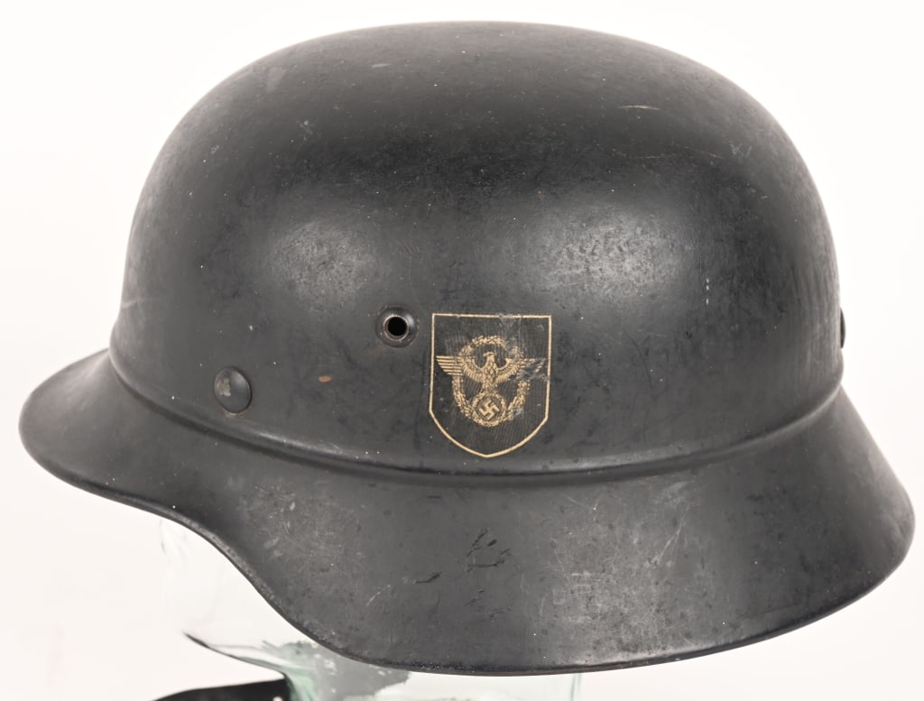 WWII NAZI GERMAN POLICE DD BEADED M40 HELMET WW2: Stamped sheet steel construction M40 style helmet with the addition of an embossed horizontal "bead" positioned at the apex of the front and rear visors and crown. Second pattern, unbordered Police ea
