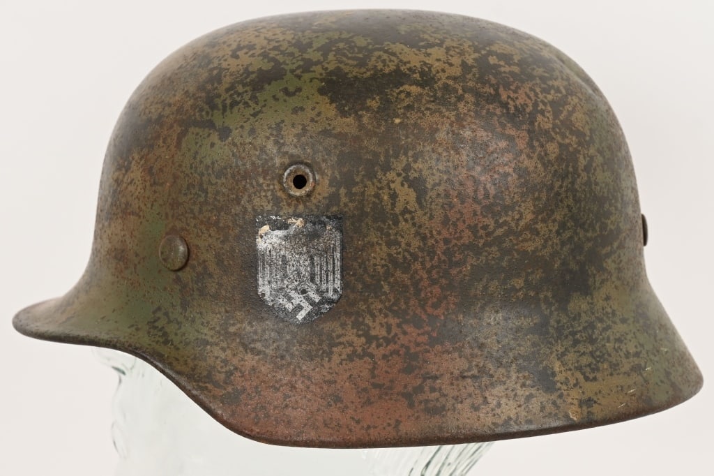 WWII NAZI GERMAN M40 NORMANDY PATTERN CAMO HELMET: M40 helmet with Normandy pattern camouflage. Helmet has a three color Camo. Helmet & liner are complete. Eagle decal is very worn but still visible Rear of rim stamped Q64 with lot number