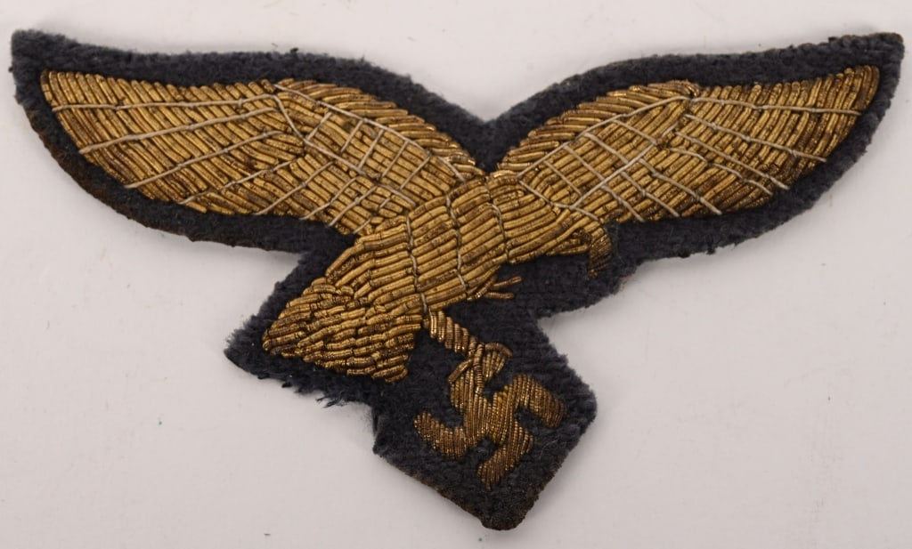 WWII NAZI GERMAN LUFTWAFFE GENERAL'S BREAST EAGLE: Nice quality, hand embroidered, second pattern Luftwaffe eagle in gilt bullion wire with golden/tan accent threads on a cut-out Luftwaffe blue/grey wool base. Hard to find! The Luftwaffe pattern