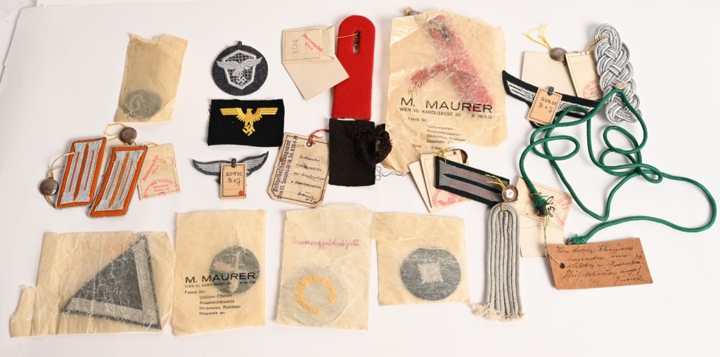 WWII NAZI GERMAN INSIGNIA W QUALITY CONTROL TAGS: Lot of exceptionally hard to find Nazi German Insignia with their quality control tags still attached. The insignia includes 1) Army Breast Eagle with paper tag attached 2) Enlisted Panzer Collar Tab