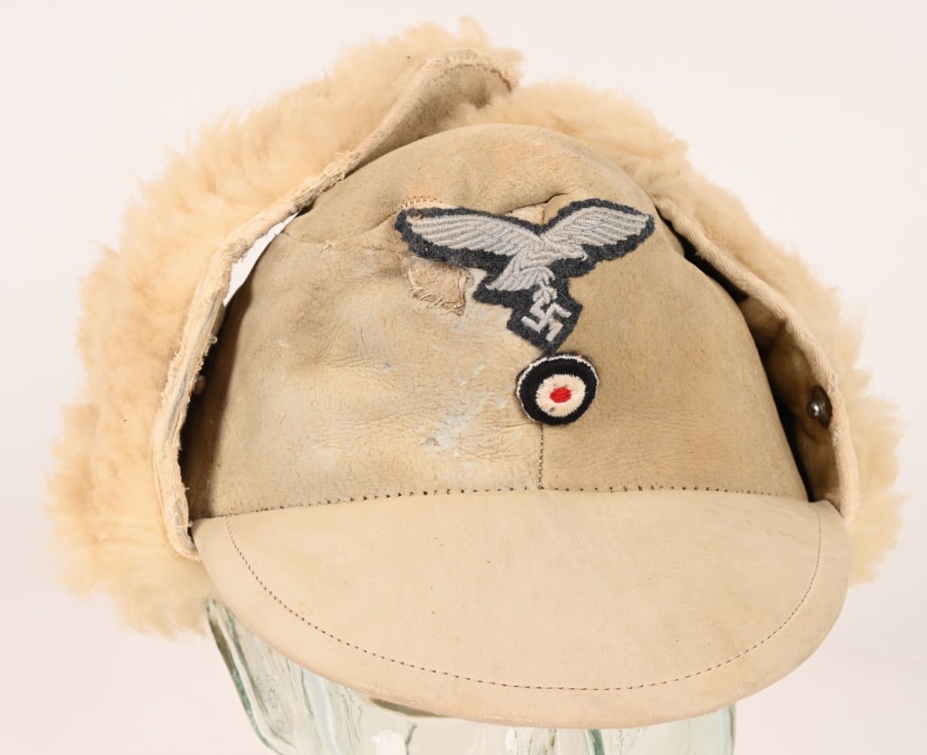 WWII NAZI GERMAN LUFTWAFFE FUR LEATHER WINTER CAP: Nice quality multi-panel patch work whitened sheep skin construction winter cap with the natural hide to the exterior and the white sheep’s wool to the interior. The cap features fold down side