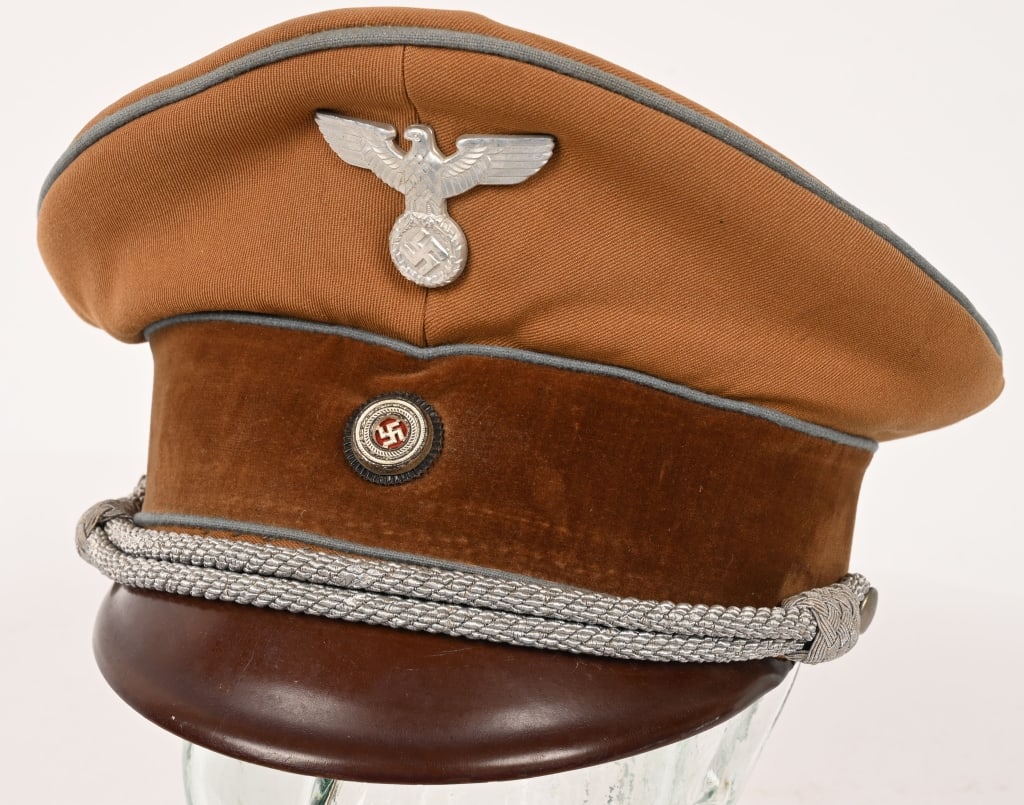 WWII NAZI GERMAN POLITICAL LEADER'S VISOR CAP WW2: Cap is constructed of ribbed, light tan cotton/rayon blend material with a light brown velvet centerband. Cap has blue wool piping to crown edge and top and bottom of centerband indicating the politic